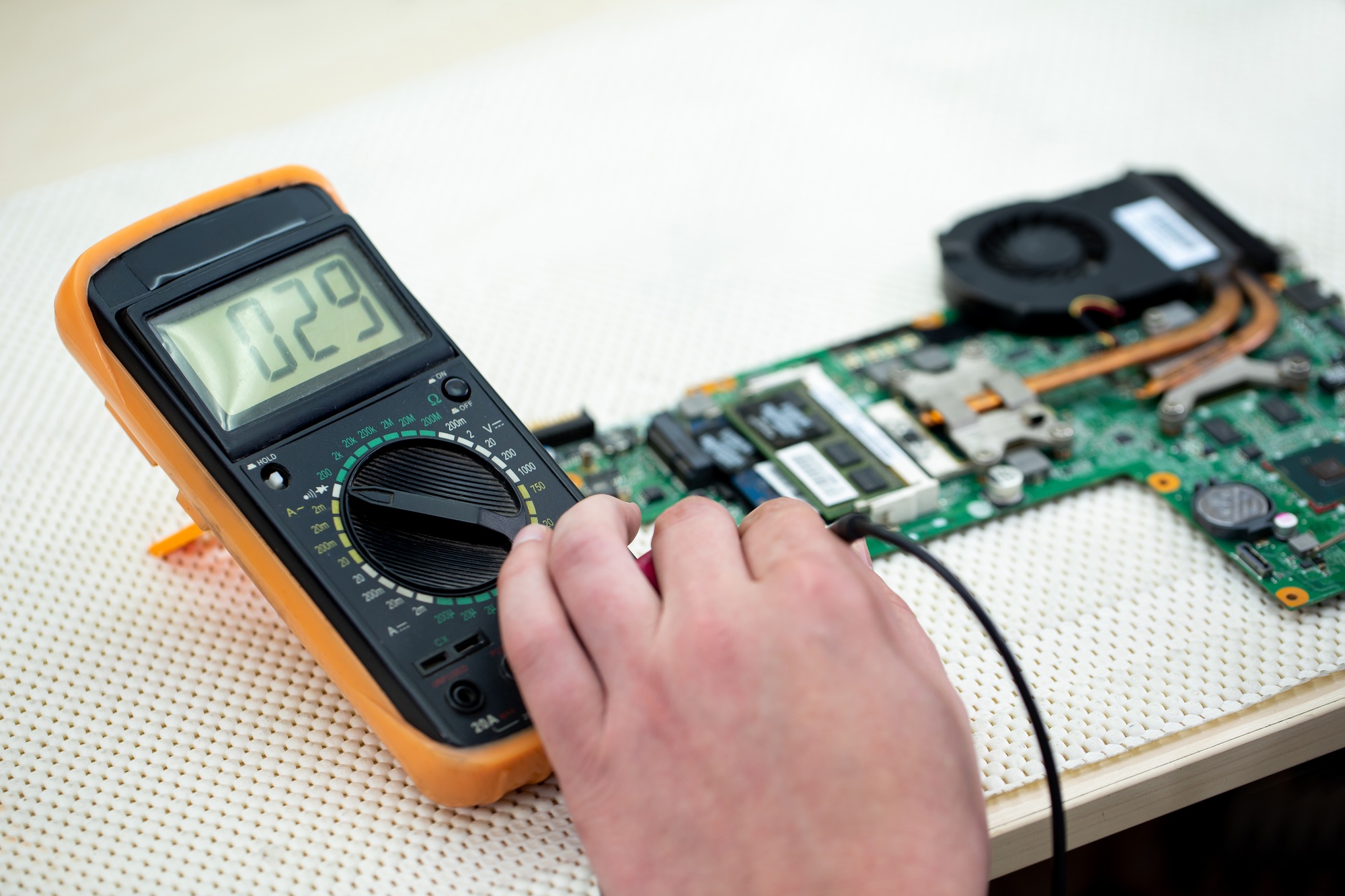 Close-up multimeter on the laptop.